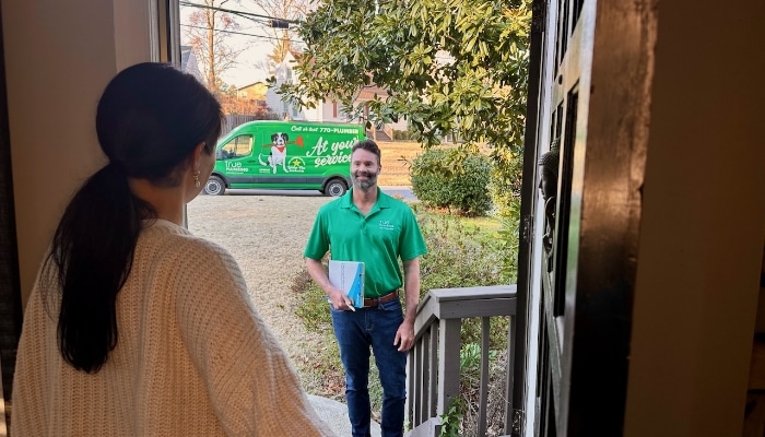 Customer Greeting Plumber At Door