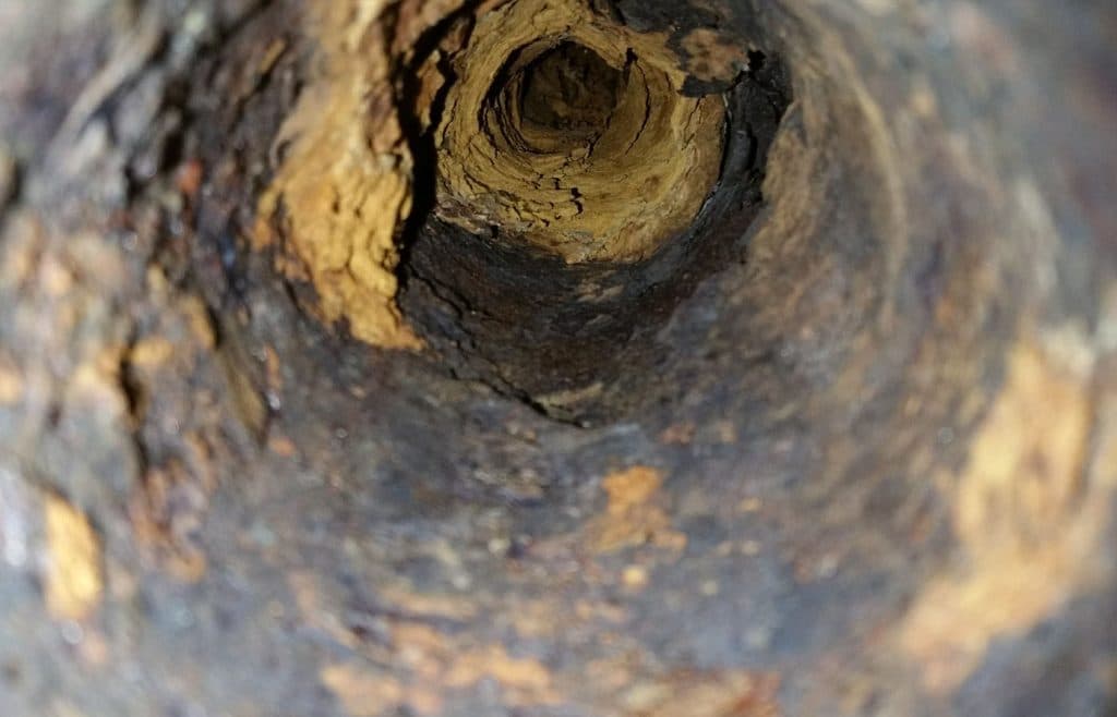 inside an old rusted sewer pipe