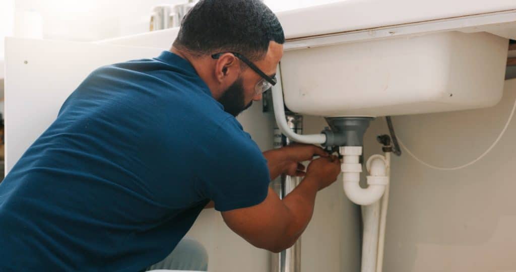 Man performing plumbing maintenance