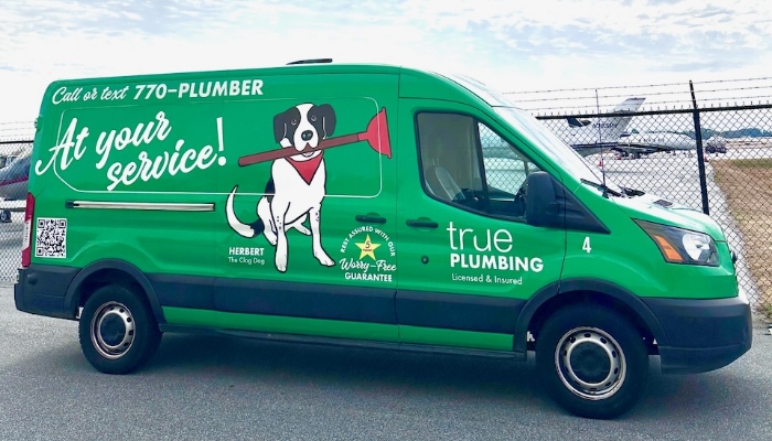 True Plumbing Van Parked At Airport True Plumbing Van Parked At Airport